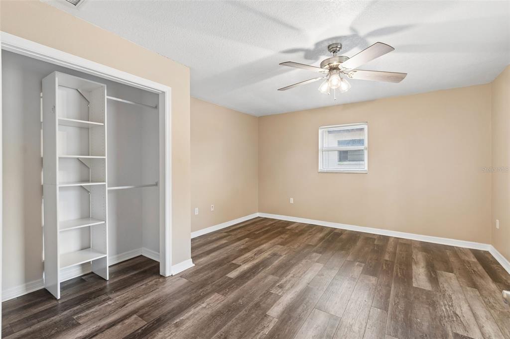 4018 Prado Drive Sarasota, FL 34235 - Photo 36 of 74 a view of an empty room with wooden floor and a window