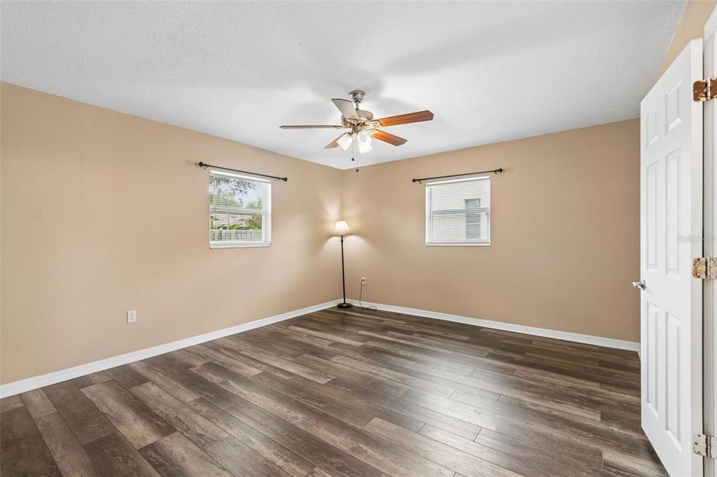 4018 Prado Drive Sarasota, FL 34235 - Photo 50 of 74 a view of a room with wooden floor and a ceiling fan