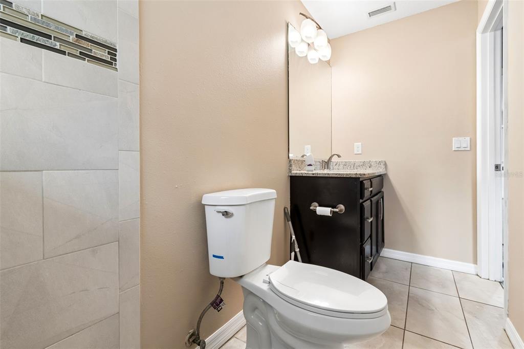 4018 Prado Drive Sarasota, FL 34235 - Photo 57 of 74 a white toilet sitting next to a bathroom sink