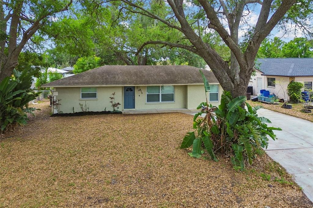 4018 Prado Drive Sarasota, FL 34235 - Photo 66 of 74 a house that has a tree in front of it