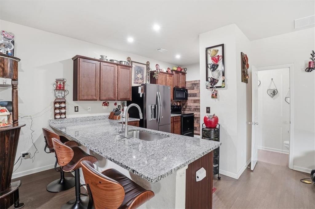 222 Seasons Valley Pendergrass, GA 30567 - Photo 14 of 30 a kitchen with stainless steel appliances granite countertop a table chairs and refrigerator
