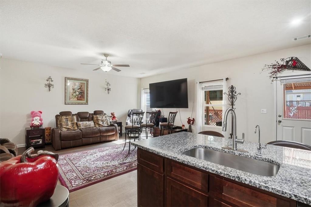 222 Seasons Valley Pendergrass, GA 30567 - Photo 15 of 30 a kitchen with granite countertop a sink and a flat screen tv