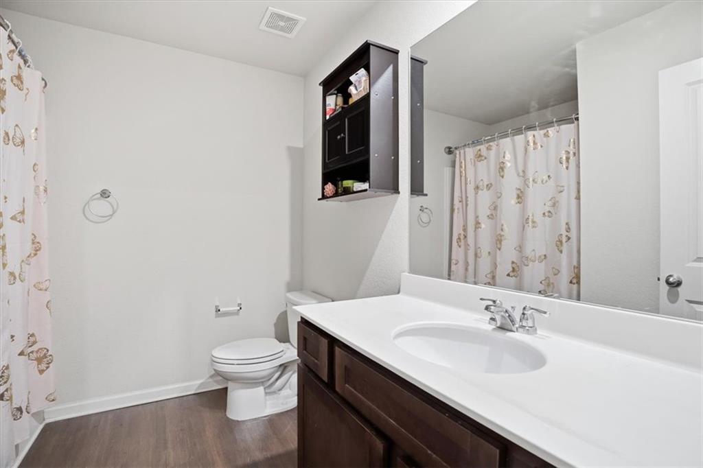 222 Seasons Valley Pendergrass, GA 30567 - Photo 17 of 30 a bathroom with a granite countertop sink toilet a mirror and shower