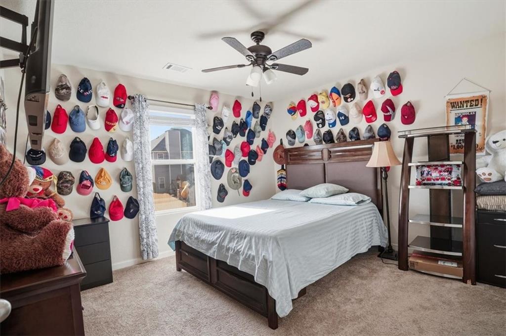 222 Seasons Valley Pendergrass, GA 30567 - Photo 20 of 30 a bedroom with bed and a chandelier