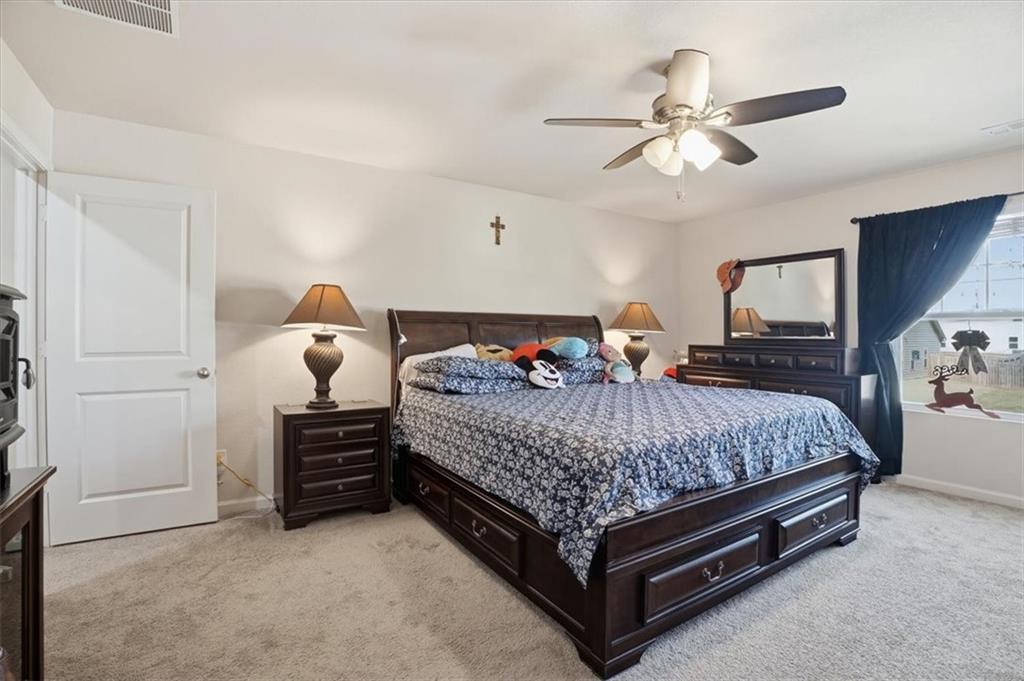 222 Seasons Valley Pendergrass, GA 30567 - Photo 24 of 30 a bedroom with a bed and ceiling fan