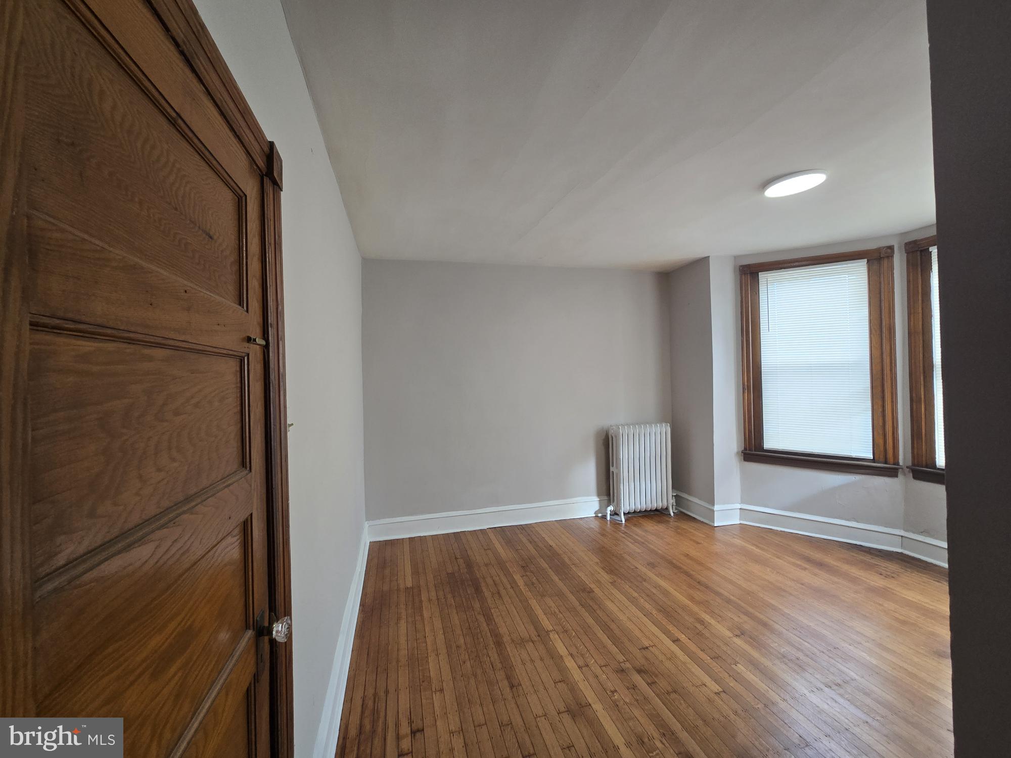 4254 North 7th Street Philadelphia, PA 19140 - Photo 13 of 26 a view of a room with wooden floor and white walls