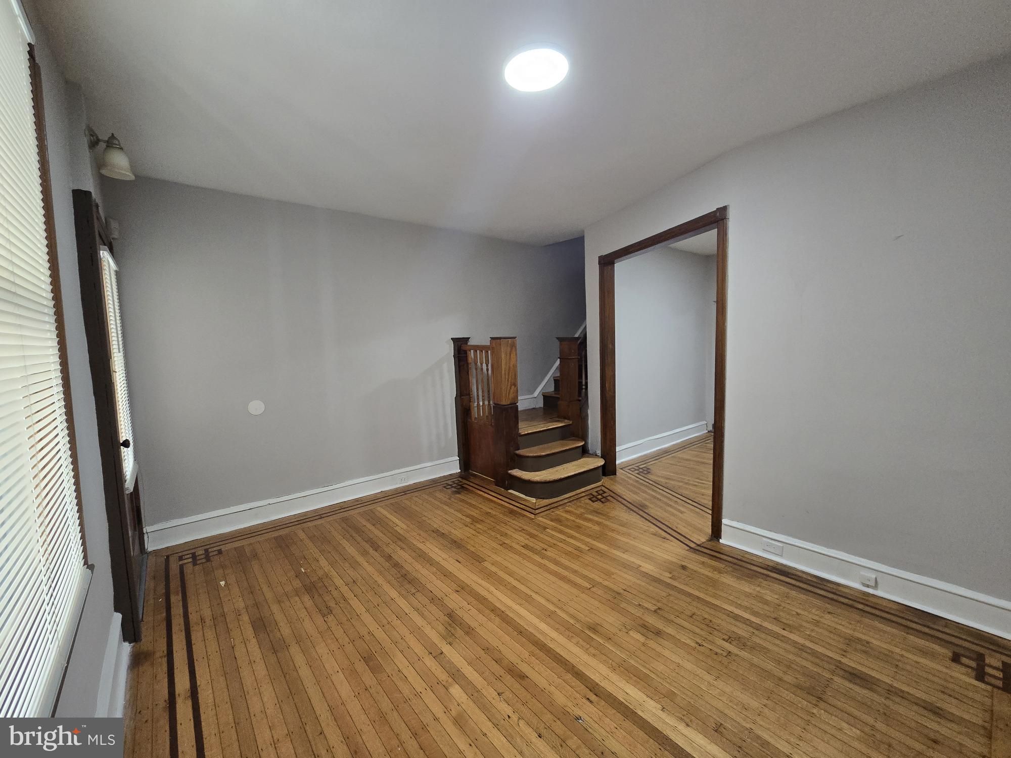 4254 North 7th Street Philadelphia, PA 19140 - Photo 8 of 26 an empty room with wooden floor and windows