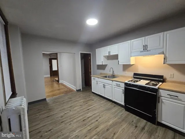a kitchen with granite countertop a stove and a refrigerator