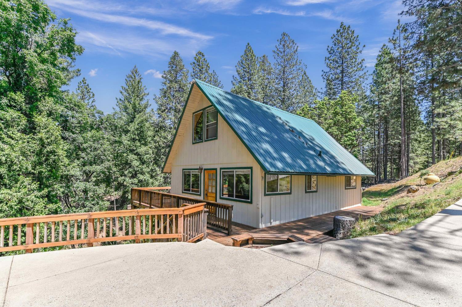 a view of a house with a yard and wooden fence