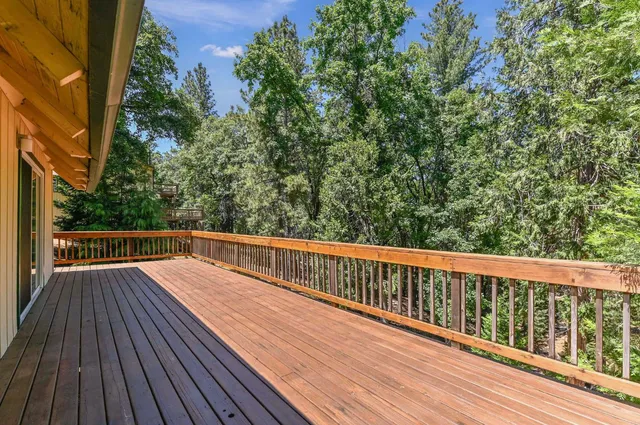 a view of balcony with wooden floor and fence