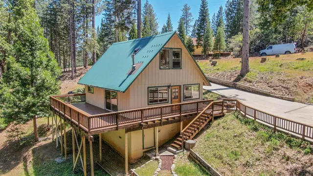 a view of a house with wooden fence