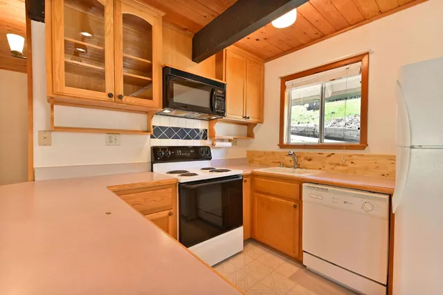 a kitchen with stainless steel appliances granite countertop a stove and a microwave