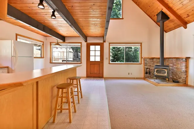 a view of livingroom with furniture staircase and windows