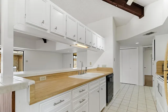 a view of a kitchen with cabinets