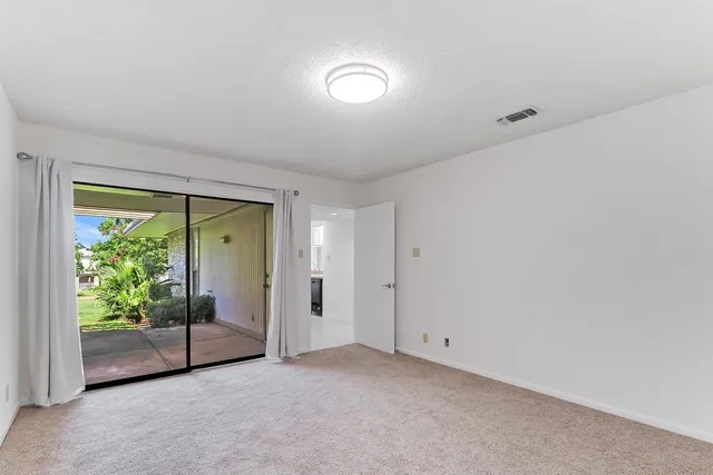 a view of an empty room with a sliding door