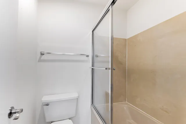 a bathroom with a shower and a toilet