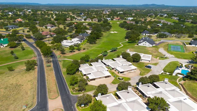 an aerial view of residential houses with outdoor space