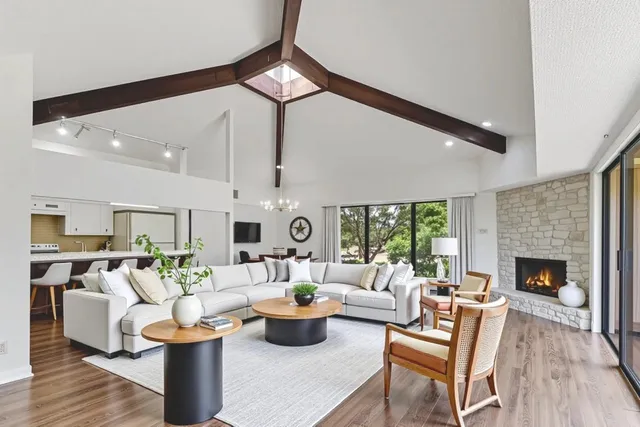 a living room with furniture fireplace and window