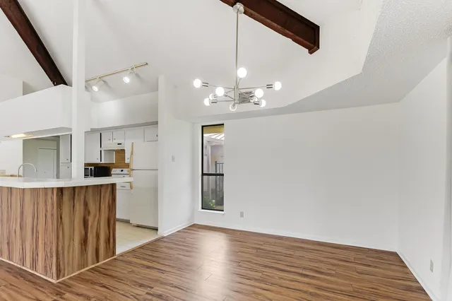 a view of a kitchen with wooden floor and a sink