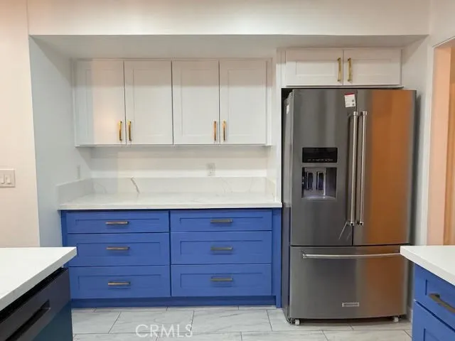 a view of an empty room with wooden floor and closet