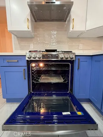 a bathroom with a double vanity sink mirror and bathtub