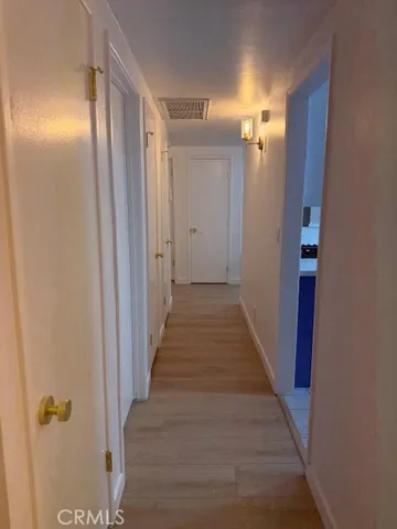 a view of a room with wooden floor and staircase