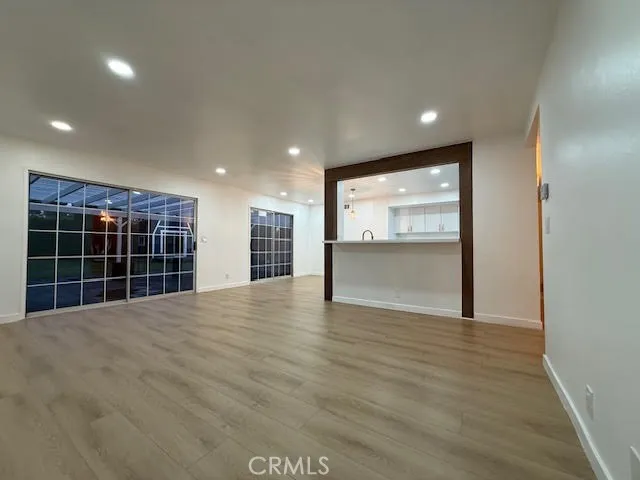 a large kitchen with stainless steel appliances a large counter top a stove and a refrigerator