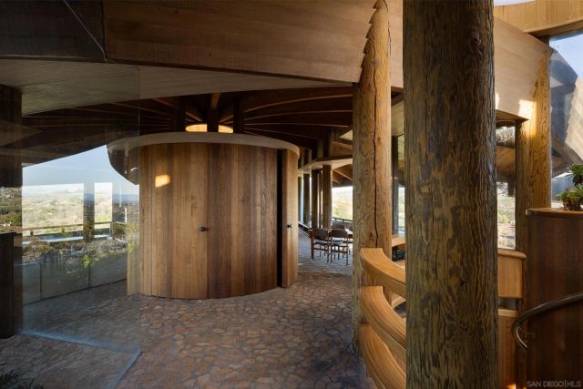 a backyard of a house with barbeque oven table and chairs