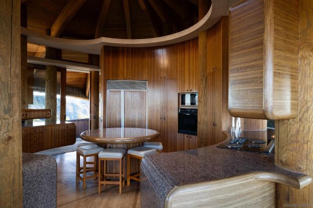 a living room with patio furniture and a floor to ceiling window
