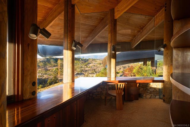 a spacious bedroom with a bed and a large window