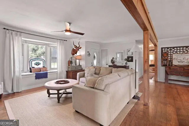 a living room with furniture a rug and a large window