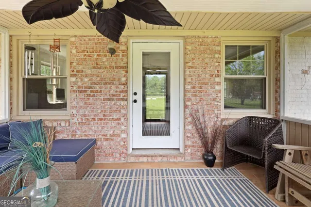 a front view of a house with outdoor seating