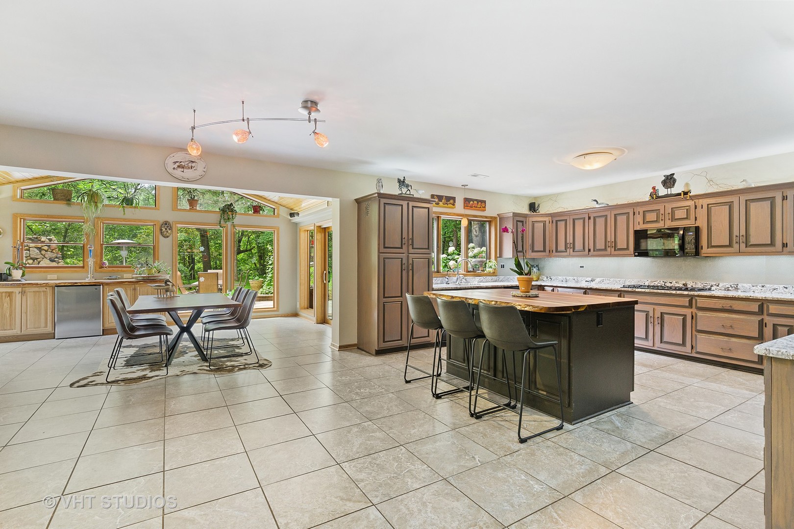 9N483 Muirhead Road Elgin, IL 60124 - Photo 12 of 40 a kitchen with a dining table chairs and white appliances