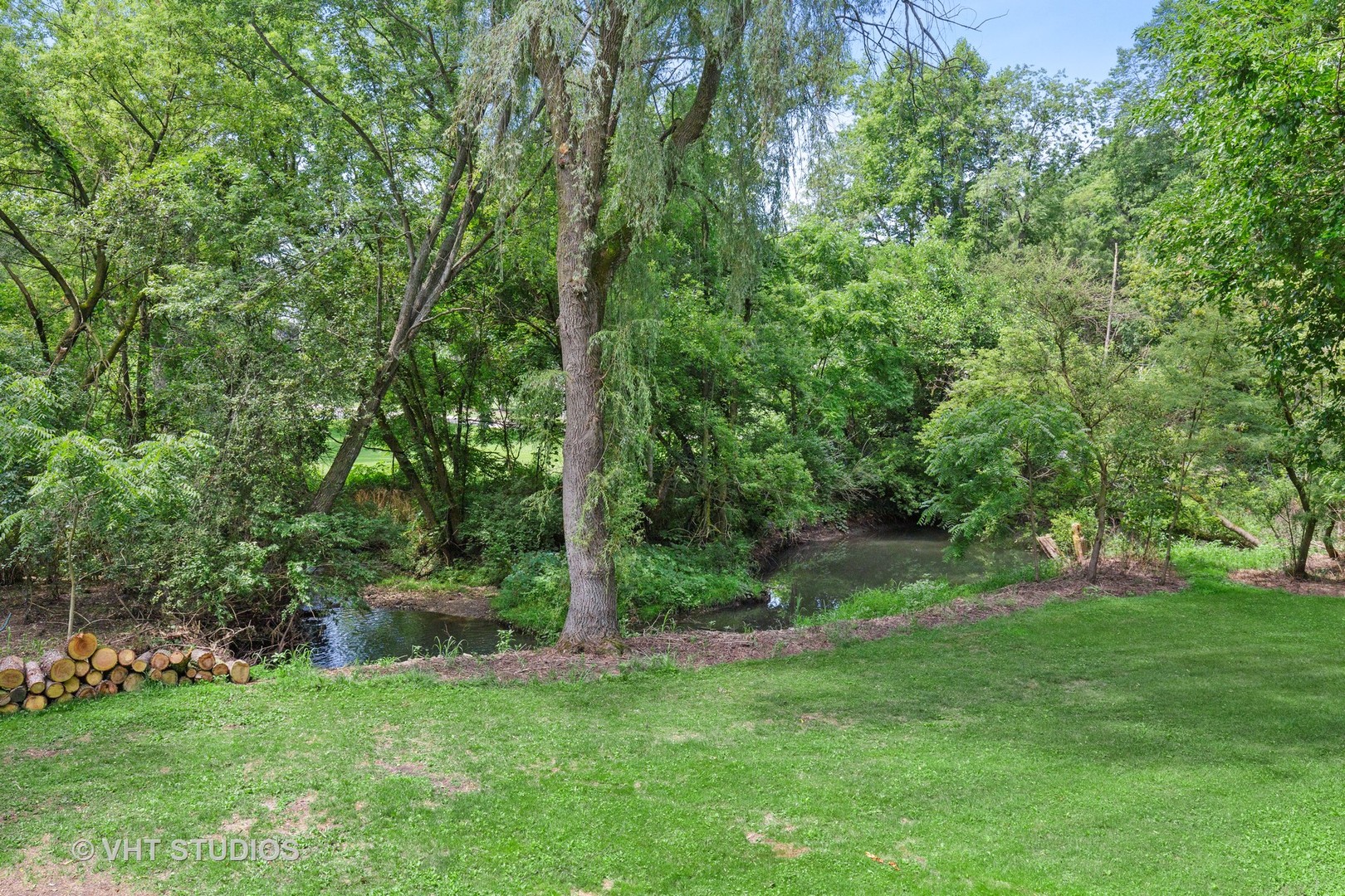9N483 Muirhead Road Elgin, IL 60124 - Photo 40 of 40 a view of a backyard with large trees