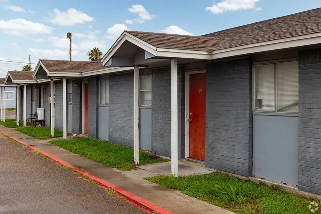 a front view of a house with a garden and plants