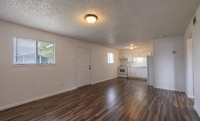 a view of a room with wooden floor and window