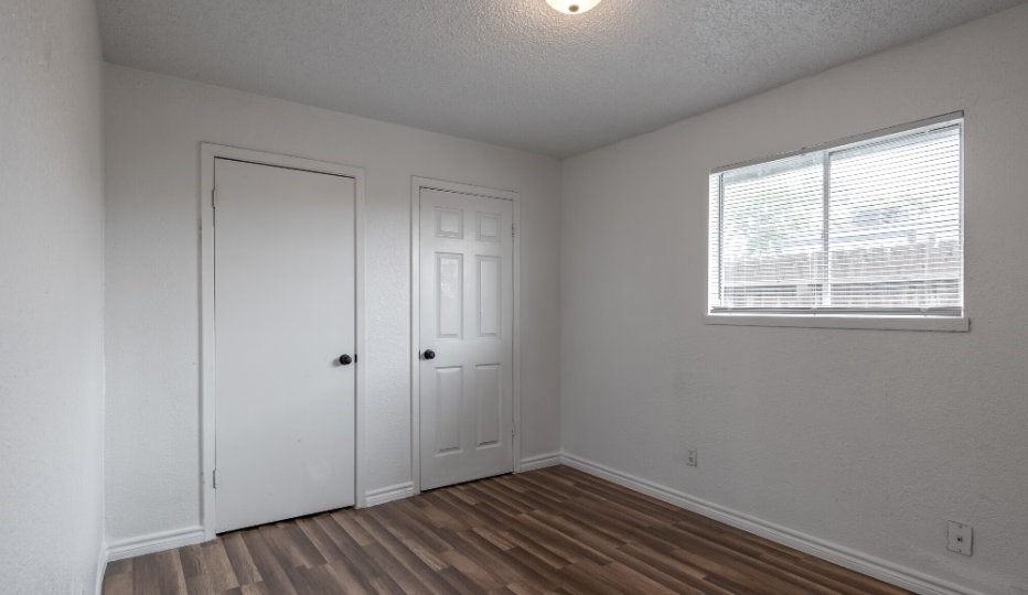1010 Behmann Street Corpus Christi, TX 78418 - Photo 9 of 10 a view of an empty room with wooden floor and a window