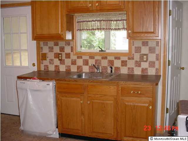 131 Mantoloking Road Brick, NJ 08723 - Photo 3 of 3 a bathroom with a granite countertop sink and a mirror