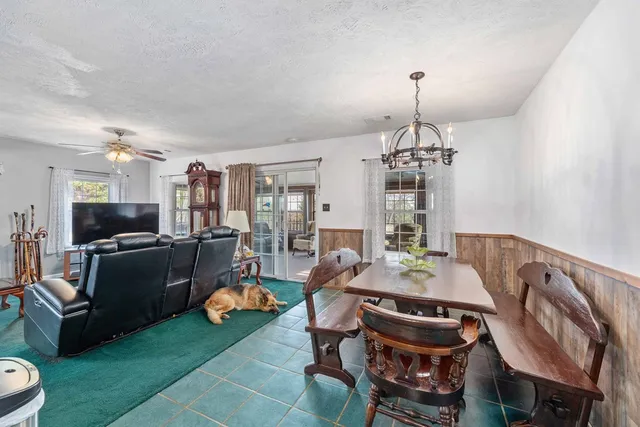 a view of a dining room with furniture and chandelier