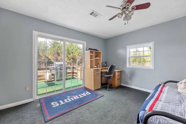 a view of a house with large trees and a yard