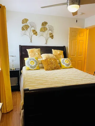 a bedroom with a bed and painting on the wall