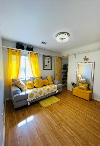 a bedroom with furniture and a wooden floor