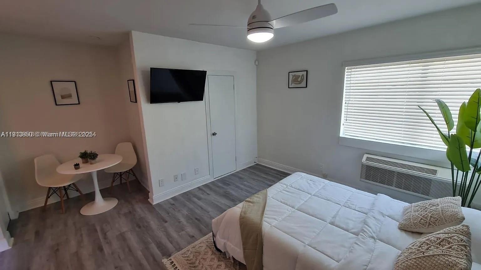 7325 Carlyle Avenue, Unit 12A Miami Beach, FL 33141 - Photo 3 of 7 a bedroom with furniture and a window