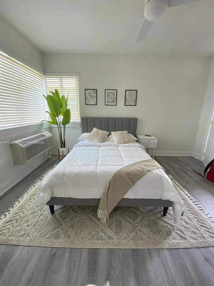 7325 Carlyle Avenue, Unit 12A Miami Beach, FL 33141 - Photo 7 of 7 a bed sitting in a bedroom next to a window