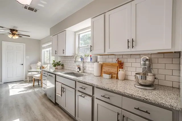 a kitchen with sink and cabinets