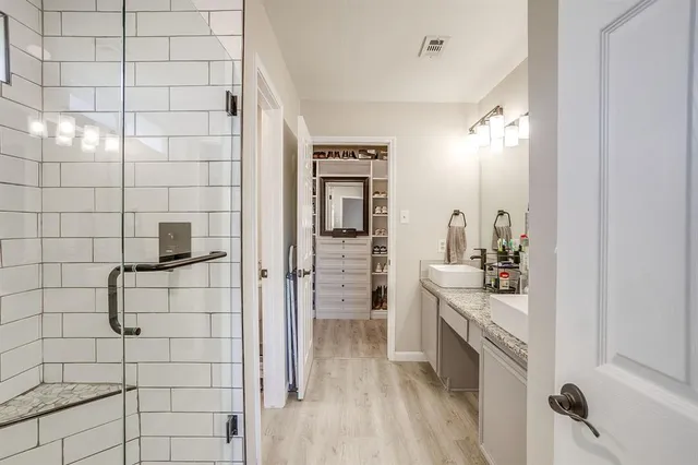 a spacious bathroom with a shower and a sink