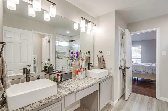 a bathroom with a granite countertop sink and a mirror