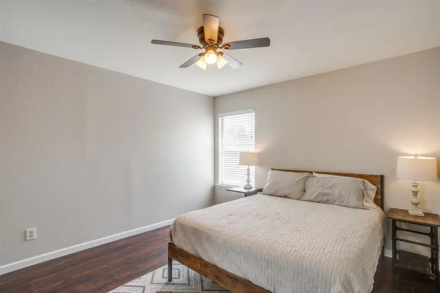 a bedroom with a bed and a ceiling fan