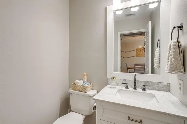 a bathroom with a sink toilet and mirror