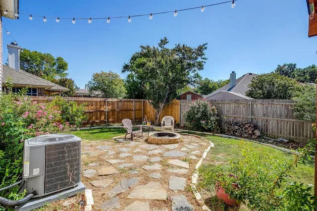 a view of patio with table and chairs and potted plants
